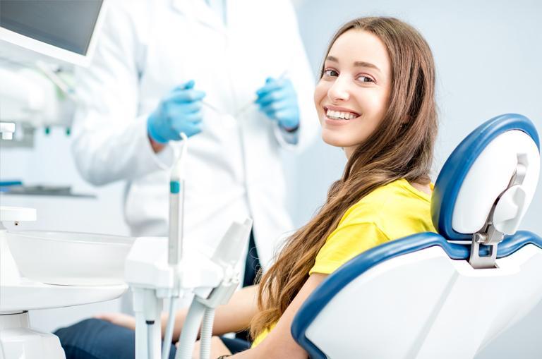 Uśmiechnięta pacjentka u stomatologa